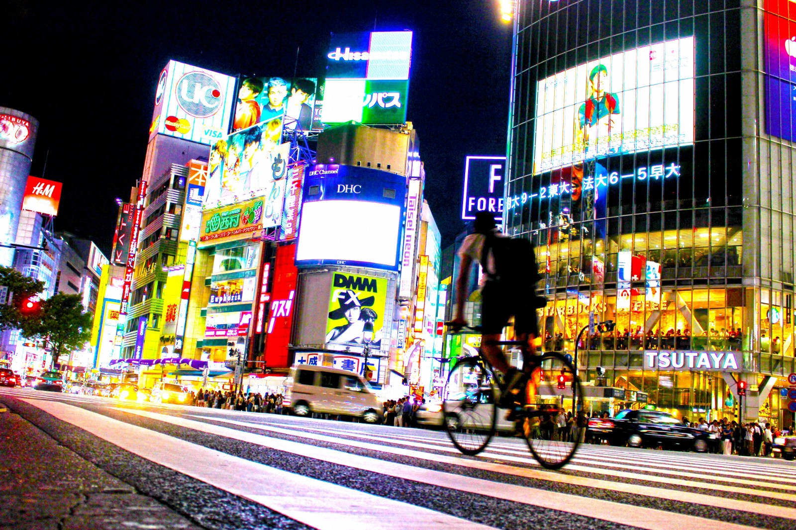 The street of Shibuya with glaring neon lights at night