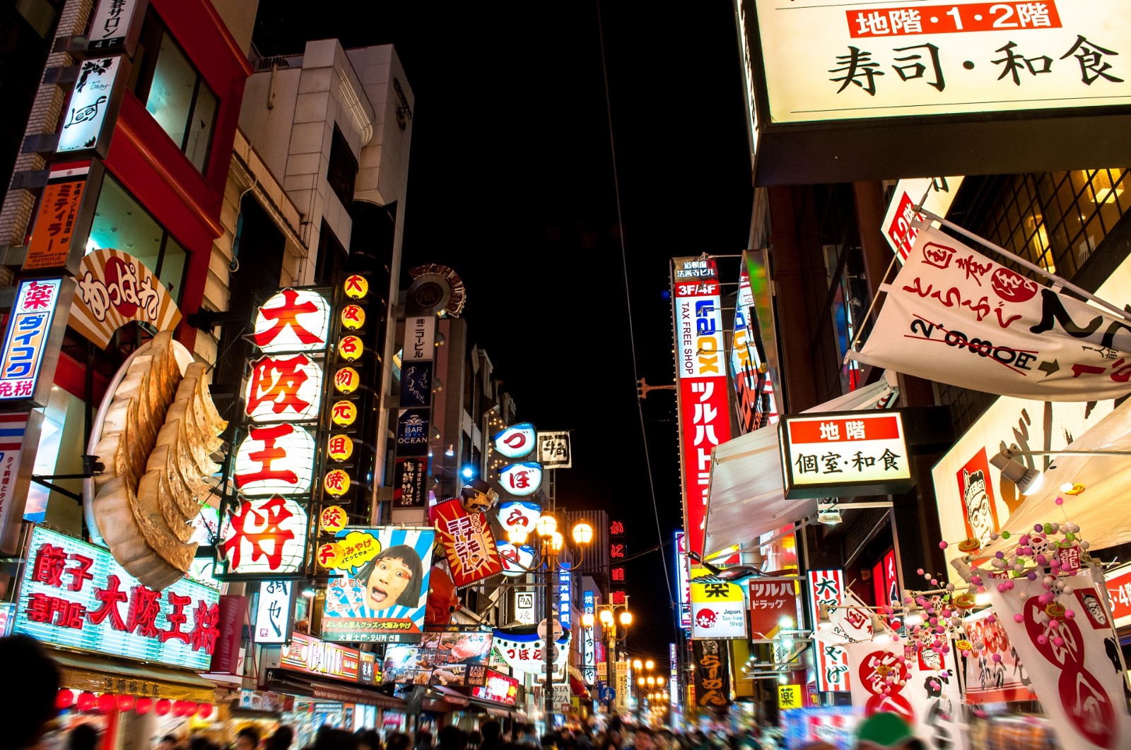 The bustling street of Dotonbori with flashy neon lights